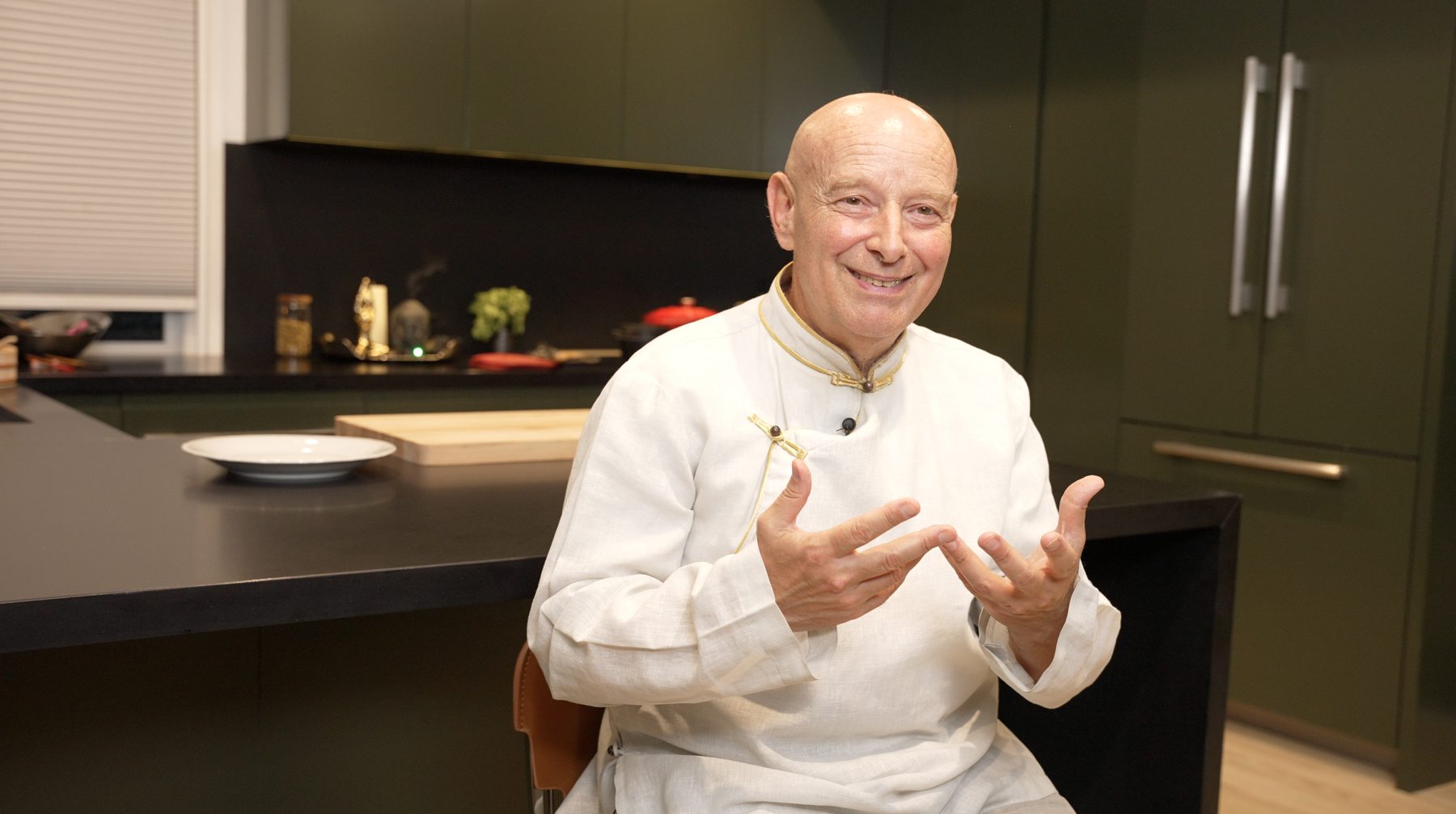 Michel Pascal talking with his hands at a kitchen counter